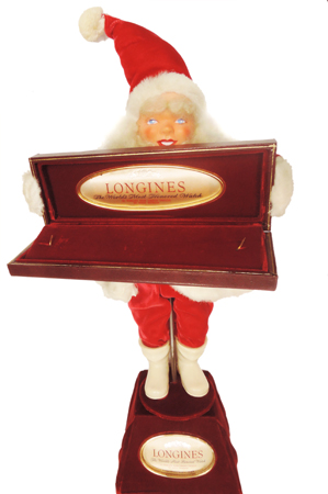 Santa Clause holding Longines watch box. Electric oscillating store display.