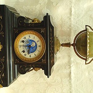 A Rare French Black Marble Mantel Clock With Revolving Globe and Moon Phases