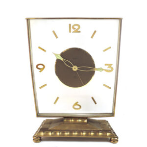 Semca Alarm, 8 Days Brass Mantel Clock with Floating Numbers. Asymmetrical style case.